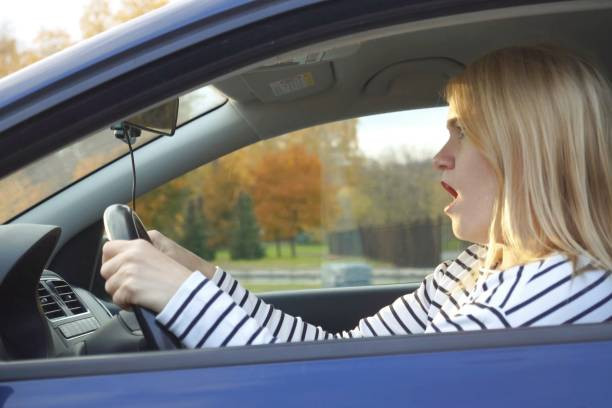 A driver staying calm and focused on the road to avoid impulsive driving behaviors.