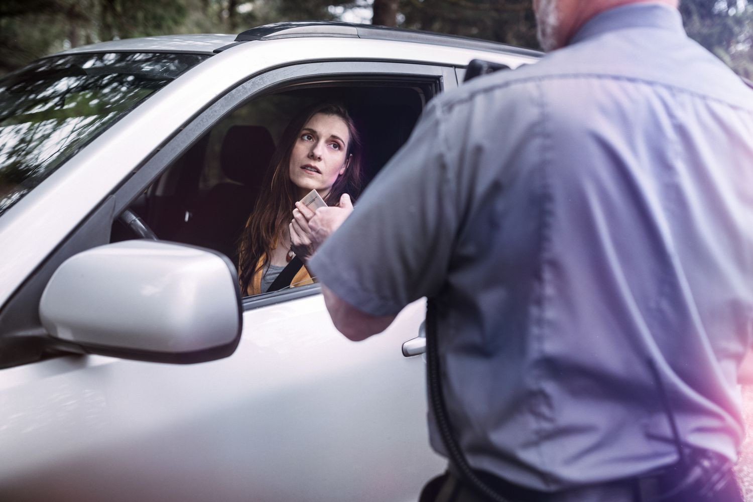 A driver preparing documents and evidence to fight a speeding ticket in court.