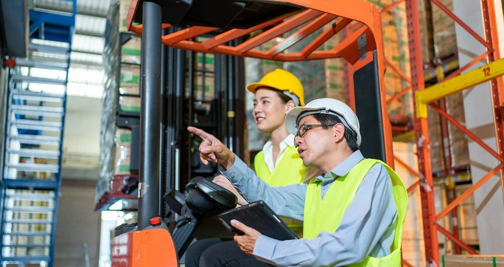 A certified forklift operator skillfully handling a load in a warehouse, demonstrating how forklift certification boosts career opportunities and earning potential.