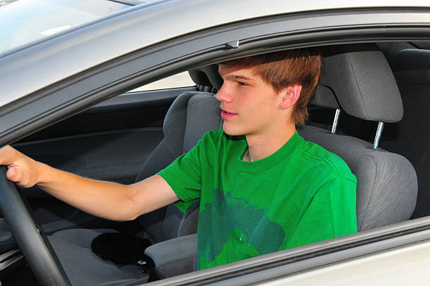 Image showing a teen behind the wheel with an instructor, representing teen drivers ed course.