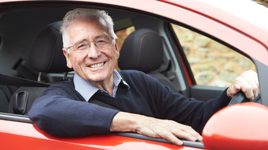 A confident adult driver practicing safe driving techniques on the road.