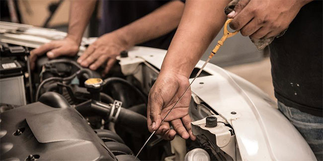 New driver checking car maintenance with a focus on essential tips.