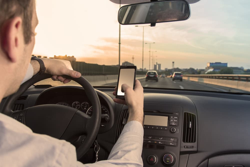 A driver focusing on the road, hands on the wheel, with no distractions in sight, complying with Georgia’s distracted driving law.