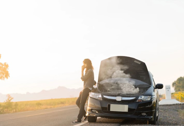 A driver safely waiting in a car on the roadside with emergency kit and hazard lights on