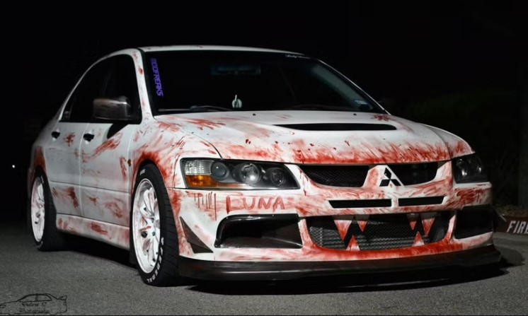 A car decorated with Halloween decorations like spider webs and pumpkins, ready for a festive and safe Halloween.